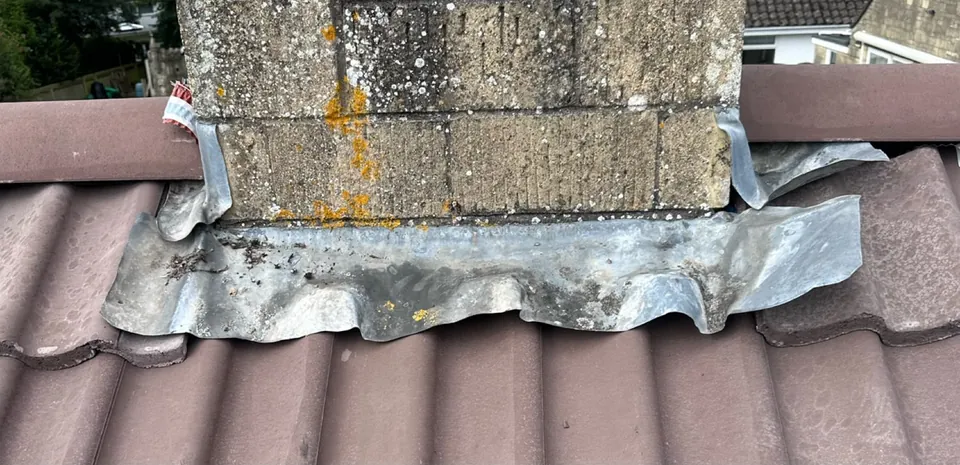 Before: torn lead apron at a chimney