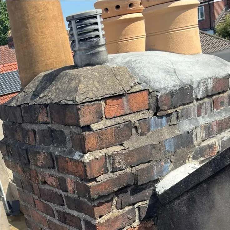Before: chimney stack with crumbling brickwork and a cracked top
