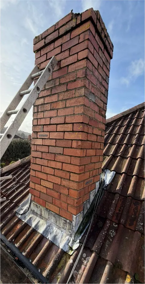 Brick chimney with new lead at the base
