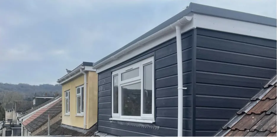Dormer clad in dark composite boards