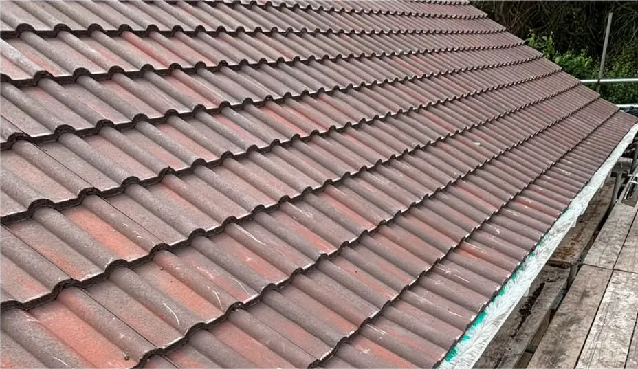 New tiles running down to the eaves