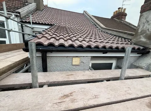 Tiled roof finished behind the scaffold